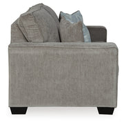 Ashley Furniture Altari loveseat with plush fabric, cushioned back, and wooden legs, shown in a cozy living room setting.