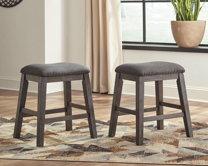 Ashley Caitbrook counter height upholstered bar stool with a cushioned seat and wooden legs, designed for modern kitchen or bar areas.