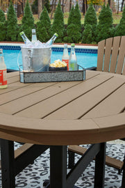 Ashley Furniture Fairen Trail outdoor dining set with a rectangular table and six matching chairs on a patio.