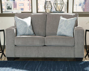 Ashley Furniture Altari loveseat with plush cushions and neutral fabric, perfect for cozy living room seating.