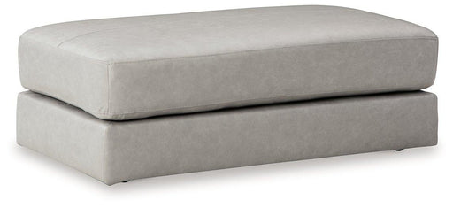 A plush oversized accent Ottoman by Ashley Furniture with soft fabric and modern design, perfect for living room decor.
