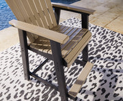Outdoor dining set by Ashley Furniture with a rectangular table and six chairs, set on a patio with greenery in the background.