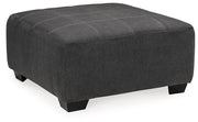 Ashley Furniture Ambee oversized accent ottoman with plush fabric and contemporary design, shown as a versatile living room piece.