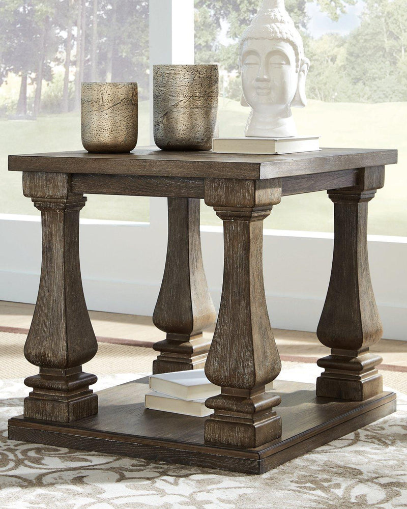 Ashley Johnelle End Table with wood finish, featuring a simple design and sturdy legs, perfect for living room use.