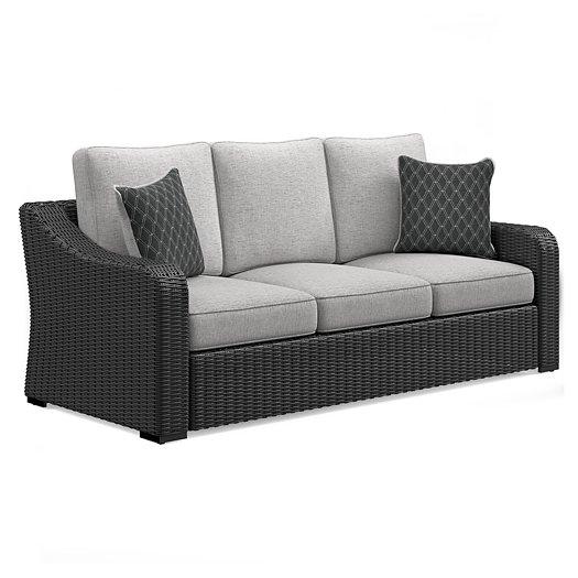 Ashley Furniture Beachcroft outdoor sofa with plush cushions, weather-resistant wicker seating for patio or garden relaxation.