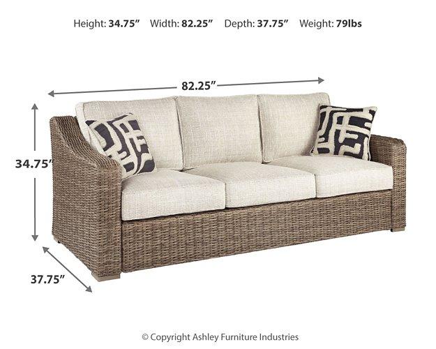 Outdoor sofa with cushion, Ashley Furniture Beachcroft model, featuring a sturdy frame and plush seating for outdoor lounging.