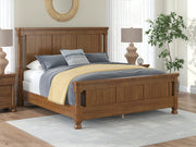 Ashley Furniture Chadworth Bed with a classic wooden frame and elegant design, shown in a warm finish.