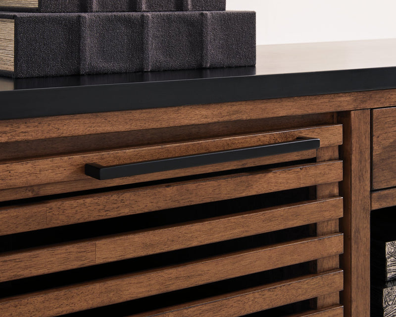 Close-up of the handle detail on the Kallari Credenza bookcase by Ashley Furniture, showcasing its stylish hardware and finish.