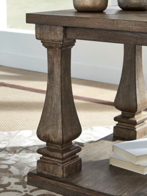 Ashley Furniture Johnelle end table with a sleek wooden surface and tapered legs, showcasing a modern, elegant design.